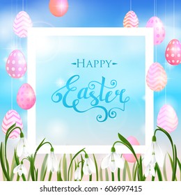 Happy Easter card with eggs, spring flowers, green grass and blue sky, lettering, calligraphy. Vector illustration EPS10.