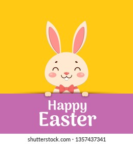 Happy Easter. Easter cartoon smiling bunny in a red bow tie is looking out of the hole and holding the text place.