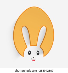 Happy Easter celebration with glossy paper cutout in bunny face shape on white background.
