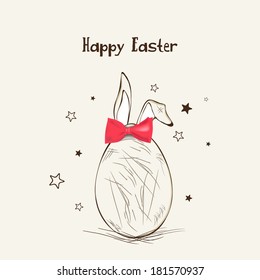 Happy Easter celebration greeting card with egg decorated by bunny ears and red bow on brown background. 