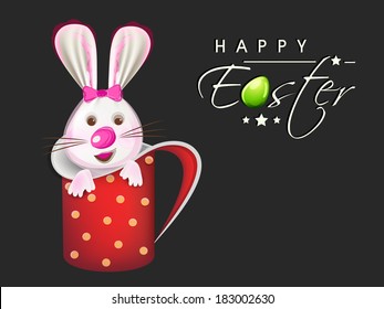 Happy Easter celebration greeting card design with cute bunny in a coffee mug on grey background. 