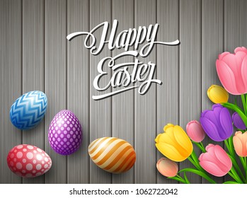 Happy Easter colorful egg with tulips flower beautifully above wooden gray background