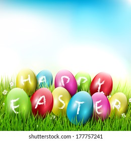 Happy Easter - colorful eggs lying in the grass 