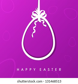 Happy Easter concept with hanging egg with ribbon on purple background.