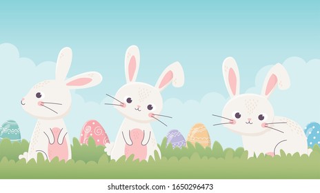 happy easter cute bunnies with eggs in the grass vector illustration
