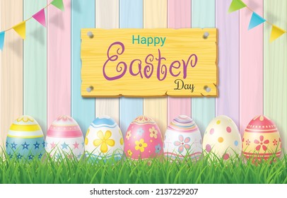 Happy Easter Day colorful egg on grass and beautiful wood background with copy space.