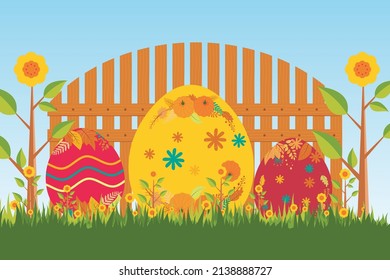 Happy Easter. Easter eggs. Decorating Easter eggs on grass on a landscape background and wooden fence 