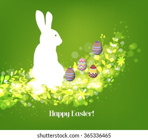 Happy easter eggs with fresh green leaves and rabbit