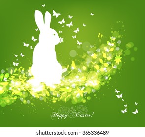 Happy easter eggs with fresh green leaves and rabbit