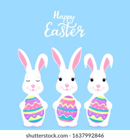 Happy Easter. Funny cartoon rabbit holding in the paws painted eggs