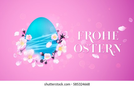 Happy Easter German text lettering and Paschal egg for greeting card. Frohe Ostern Vector decorated egg in spring flowers of cherry blossom on pink background for greeting card