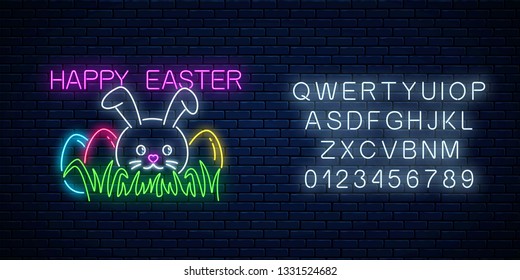 Happy easter glowing signboard with bunny and colored eggs on grass with alphabet in neon style on dark brick wall background. Easter funny greeting banner. Vector illustration.