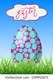 Happy Easter greeting card. Bright blue and pink egg in green grass and hand drawn lettering in a frame. Vector spring illustration.