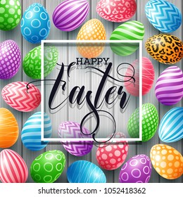 Happy Easter greeting card with colored eggs, and frame on wood background