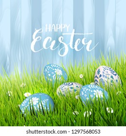 Happy Easter greeting card with eggs lying in the grass. Brush lettering