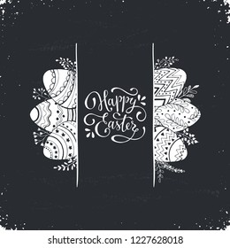 Happy Easter greeting card isolated on blackboard. Easter eggs composition hand drawn white on black. Decorative horizontal frame from eggs with leaves and calligraphic wording.