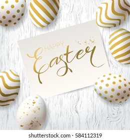 Happy Easter greetings Card.  Vector Template with golden eggs on a wooden rustic table. Calligraphic inscription. Minimalistic design