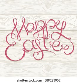Happy easter Hand drawing lettering headline on wooden background. Easter greeting card