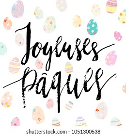 Happy Easter Joyeuses Paques french hand written brush lettering with decorated eggs on white background.