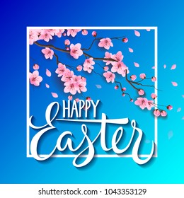 Happy Easter lettering with blooming sakura twig in frame on blue background. Calligraphic inscription can be used for greeting cards, festive design, postcards, posters.