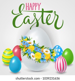 Happy Easter lettering with colored eggs and floral wreath. Calligraphic inscription can be used for greeting cards, festive design, postcards, posters.