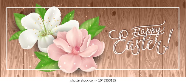 Happy Easter lettering in frame with pink and white blossoms and glittering on wooden background. Calligraphic inscription can be used for greeting cards, festive design, banners, posters.