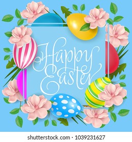 Happy Easter lettering in square frame with colored eggs and pink blossoms on blue background. Calligraphic inscription can be used for greeting cards, festive design, postcards, posters.