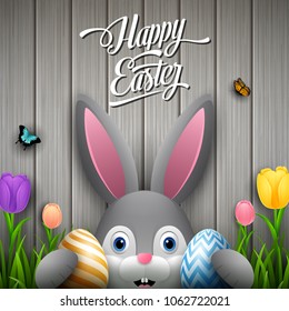 Happy easter with rabbit holding two egg colorful on wooden gray background