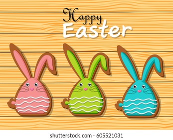 Happy Easter rabbit shape cookies on brown wooden background