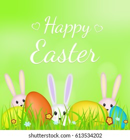 Happy Easter. Rabbits and colorful eggs in grass.