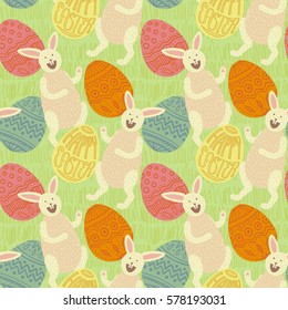Happy Easter seamless pattern. Beige bunnies and colorful eggs with decorations and hand written lettering in egg shape. Yellow, pink, blue, orange. Green spring grass background.
