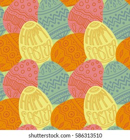 Happy Easter seamless pattern. Big colorful eggs with decorations and hand written lettering in egg shape. Yellow, pink, blue, orange. Green spring grass background.