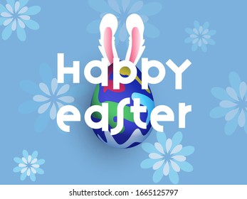 Happy Easter Text with Realistic Printed Egg and Bunny Ear on Blue Floral Background.