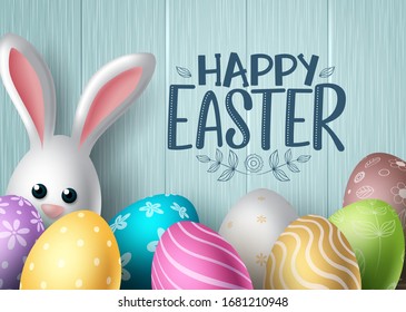 Happy easter vector background design. Happy easter text with colorful egg patterns and cute bunny rabbit in wood textured background for easter holiday celebration. Vector illustration. 