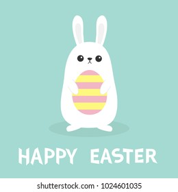 Happy Easter. White bunny rabbit holding painted pattern egg. Funny head face. Big ears. Cute kawaii cartoon character. Baby greeting card Blue pastel color background. Flat design Vector illustration