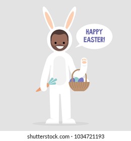 Happy easter. Young black male character wearing a white bunny costume and holding a basket with dyed eggs. Holidays. Flat editable vector illustration, clip art. Culture and celebrations.