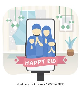 Happy Eid greeting from a muslim family through video call on mobile phone placed on a phone stand holder at home.  The family consists of 4 people, which is a father, mother, daughter, and son.