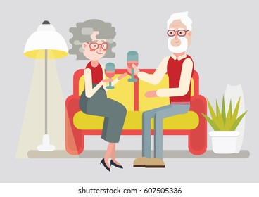 Happy elder couple sitting on sofa. Cozy house interrior