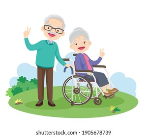 happy elderly gesture victory hand sitting on wheelchair in the park. Grandfather and Grandmother so happy victory gesture On the field grass 