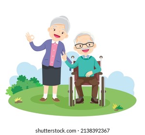 happy elderly gesture victory hand sitting on wheelchair in the park. Grandfather and Grandmother so happy victory gesture On the field grass 