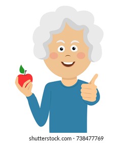 Happy elderly woman holding a red apple giving thumbs up on white