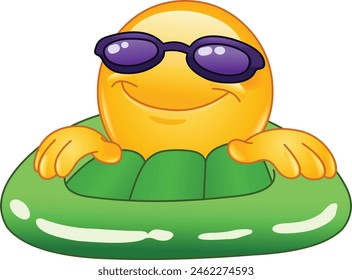 Happy emoji emoticon with sunglasses on a green inflatable pool or sea water mattress