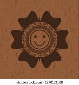 happy face icon inside badge with wood background