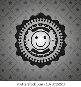 happy face icon inside black emblem