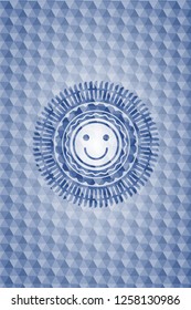 happy face icon inside blue emblem or badge with geometric pattern background.