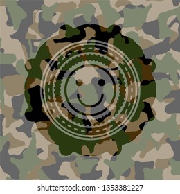 happy face icon inside camouflage emblem