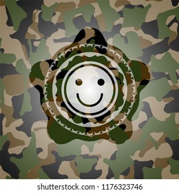 happy face icon inside camouflaged emblem