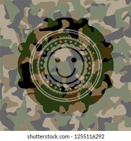 happy face icon inside camouflaged emblem