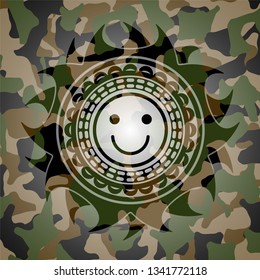 happy face icon inside camouflaged emblem