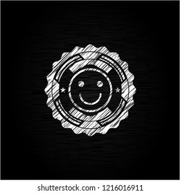 happy face icon inside chalk emblem written on a blackboard